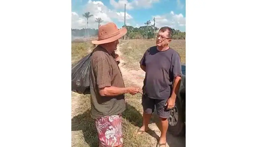 two men standing next to a car