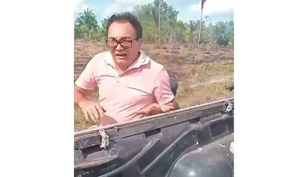 a man in a pink shirt