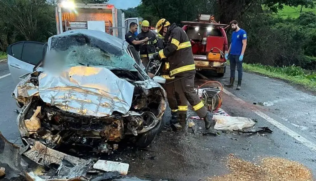 a group of firefighters working on a wrecked car